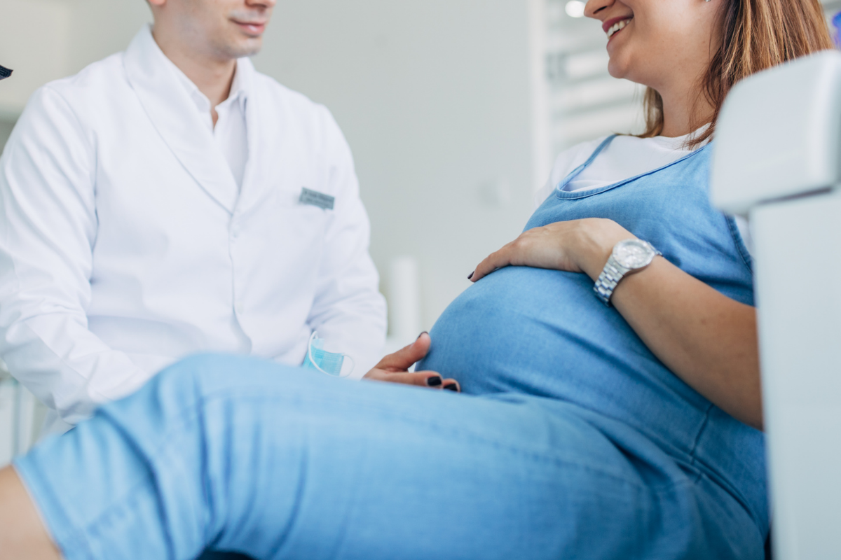 Pregnant woman at dental office smiling